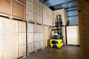 An image of a Hinckley storage forklift truck about to pick up a storage crate